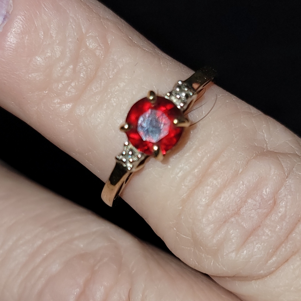 Beautiful gold colored ring with bling! Shiny round cut ruby red gem
